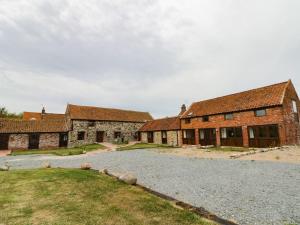 an old brick building with a gravel road in front at Mulberry Manor in Hull