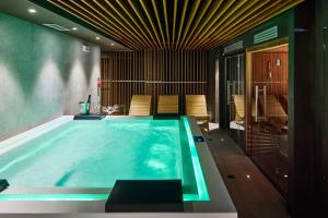a large swimming pool in a house at Chalet Morel 1586 Hotel & Spa in Limone Piemonte
