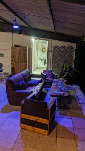 a living room with couches and a table at Horizon Mohair in Saint-Projet +33 photos