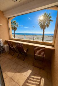 a view of the beach from a window at Studio cabine première ligne in Fleury