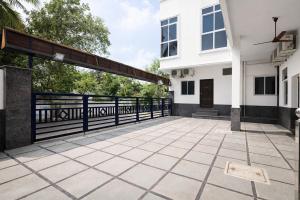 a patio of a house with a black fence at Via Neverland Residency in Pedappai