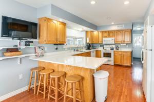a kitchen with wooden cabinets and a white counter top at Shop, Dine, Unwind! Family Home in Dtwn Bar Harbor in Bar Harbor