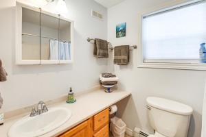 a bathroom with a sink and a toilet and a window at Shop, Dine, Unwind! Family Home in Dtwn Bar Harbor in Bar Harbor +19 photos