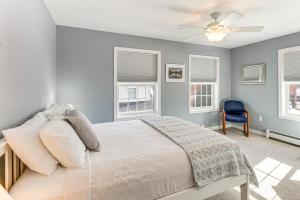 a bedroom with a bed with a ceiling fan and windows at Shop, Dine, Unwind! Family Home in Dtwn Bar Harbor in Bar Harbor