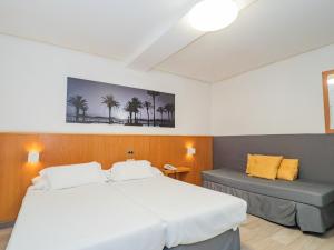 a bedroom with two beds and a bench in it at Hotel del Mar Vigo in Vigo +132 photos
