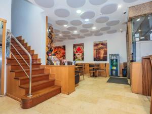 a lobby with a staircase and a dining room at Hotel del Mar Vigo in Vigo