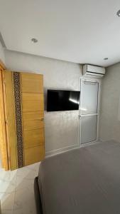 a kitchen with a refrigerator and a bed in a room at Selouane in Selouane