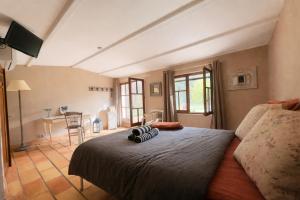 a bedroom with a bed with two pillows on it at Mas la Provence in L'Isle-sur-la-Sorgue