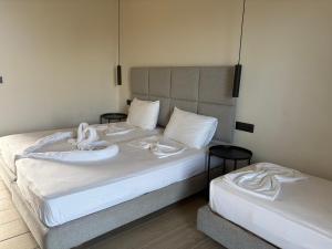 a bedroom with two beds with towels on them at Barbie II in Ialysos