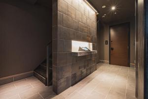 a stone wall in a hallway with a fireplace at The LOFT INN NAGASAKI in Nagasaki
