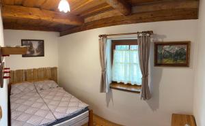 a bedroom with a bed and a window at Drevenica pod Tlstou in Blatnica +30 photos