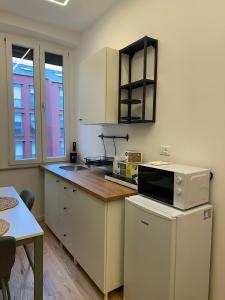 a kitchen with a microwave and a counter top at Stay & Solution Apartment in Trieste