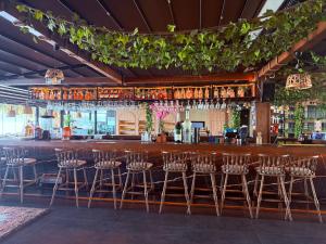 a bar with a bunch of bar stools at Grand Alisa Hotel (Ex. Royalisa Hotel) in Alanya