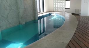a large swimming pool in a room with at GUARULHOS FLAT CENTER - Apart-Hotel in Guarulhos