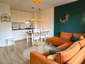a living room with a couch and a table and a kitchen at Vakantie appartement Chava WE09 in Westkapelle