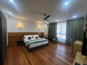 a bedroom with a bed and a ceiling fan at Pines Dirang Homestay in Chug