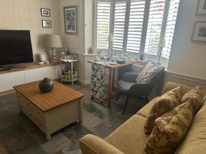 a living room with a couch and a table at Morgraig in Cardiff