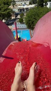 a person laying on a red blanket next to a skate ramp at Apartment Ivana in Murter