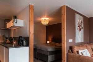 a room with a bed and a couch and a table at Appartement Wadpier in Buren