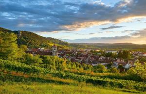 a small town in the hills with a castle at L'aube de Vouglans 5 kms des plages in Pont-de-Poitte