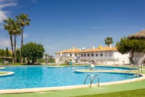 a large swimming pool in front of a building at Bungalow Pink summertime in Alicante