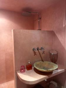 a bathroom sink with a faucet on a shelf at Studio rose in Cassis +11 photos