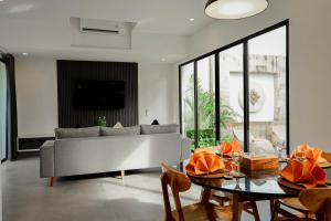 a living room with a couch and a table at Dkenyeri Villa by Aayan in Tanah Lot