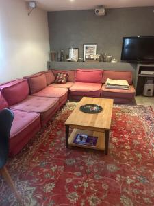 a living room with a couch and a coffee table at Studio rose in Cassis