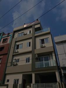 a building with a sign on top of it at Rr suites in Kākināda +25 photos