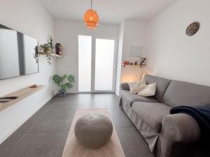 a living room with a couch and a table at apartment in La Santa, Lanzarote, village by the Sea in La Santa