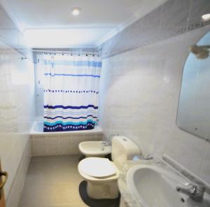 a bathroom with a toilet and a sink at Villamar Orange Costa in Benicàssim +14 photos