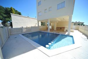 a swimming pool in the backyard of a house at Villamar Orange Costa in Benicàssim