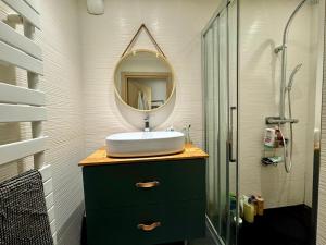 a bathroom with a sink and a mirror at L annexe in Saint-Jean-d'Aulps