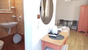 a bathroom with a sink and a sewing machine on a table at Guest House Sunflowers in Pomorie +92 photos