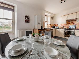 a dining room with a table and chairs and a kitchen at Pembroke Lake House in Pembroke