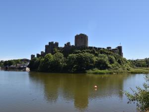 an island in the water with a castle in the background at Pembroke Lake House in Pembroke