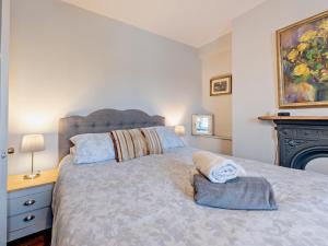 a bedroom with a large bed with a fireplace at Pembroke Lake House in Pembroke
