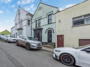 a row of parked cars parked in front of buildings at Pembroke Lake House in Pembroke +7 photos
