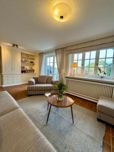 a living room with a couch and a table at Landhaus-Duenenhof in Rantum