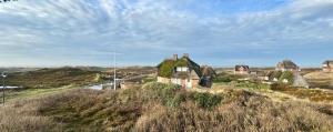 an old house on top of a hill at Landhaus-Duenenhof in Rantum