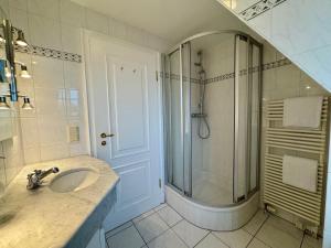 a bathroom with a sink and a shower at Landhaus-Duenenhof in Rantum +14 photos