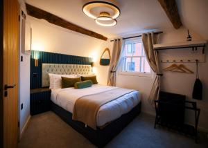 a bedroom with a large bed and a window at City Rooms by Hiive in Worcester