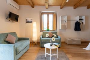 a living room with two couches and a table at Le Vie del Borgo | 3 dimore indipendenti a Civita in Civita