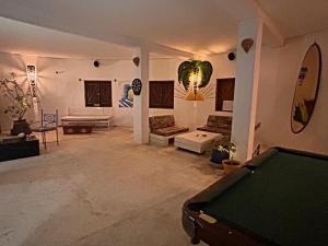 a large living room with a pool table in it at Kayzen house in Ngaparou