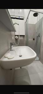 a bathroom with a white sink and a shower at HOUSE Riccardo, vicino al parco Nelson Mandela in Sestri Levante +9 photos