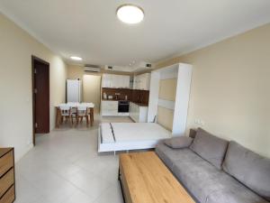 a living room with a couch and a kitchen at Santa Marina Breeze - One bedroom apartment in Sozopol