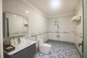 a bathroom with a toilet and a sink and a shower at Khách sạn Ngọc Anh in Long Hai