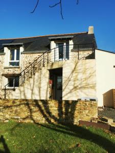 a house with a shadow of a tree at Le studio in Pontchâteau