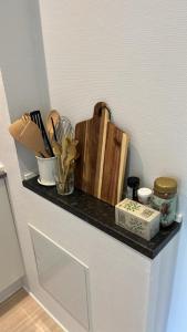 a shelf with some utensils on a wall at Billund mini hostel room 3 in Billund