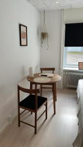 a dining room with a table and a chair at Billund mini hostel room 3 in Billund